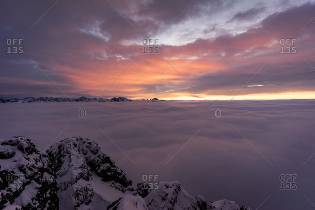 Snowcapped peak of Aggenstein mountain at moody sunset