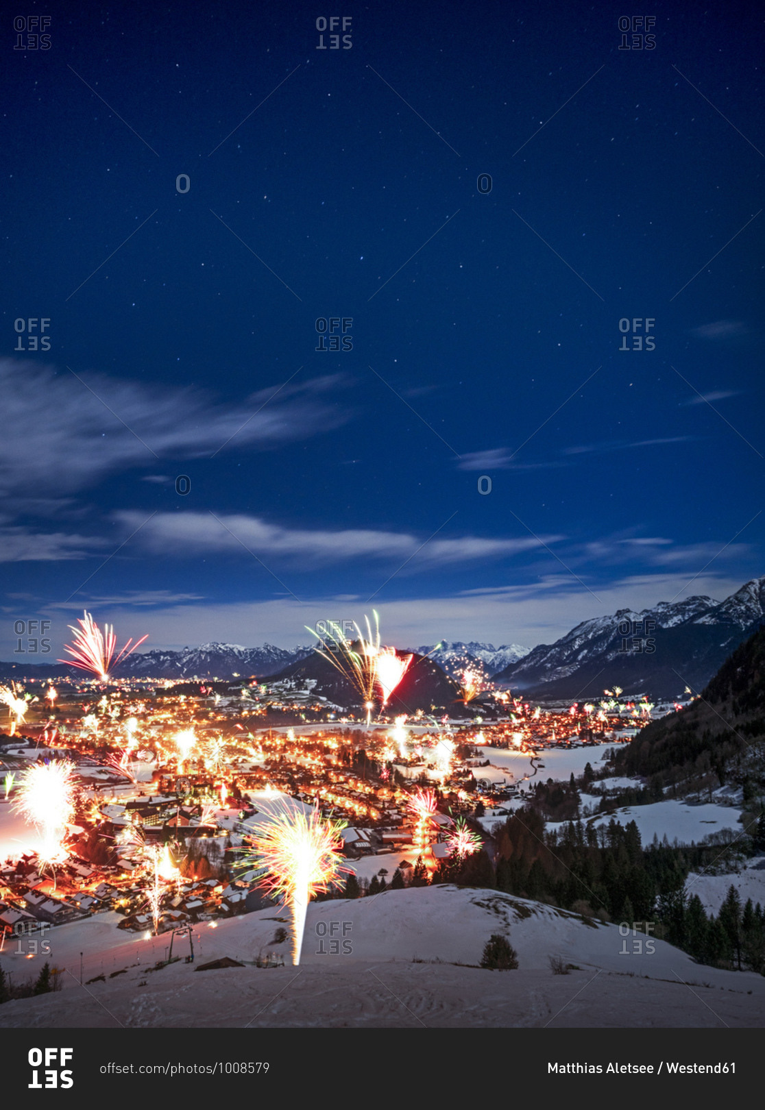 Germany- Bavaria- Edelsberg- Fireworks exploding over mountain town during New Years Eve