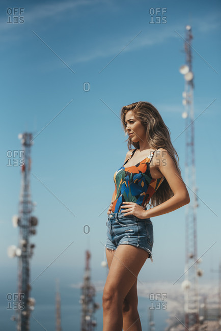 Young woman standing in front of antennas