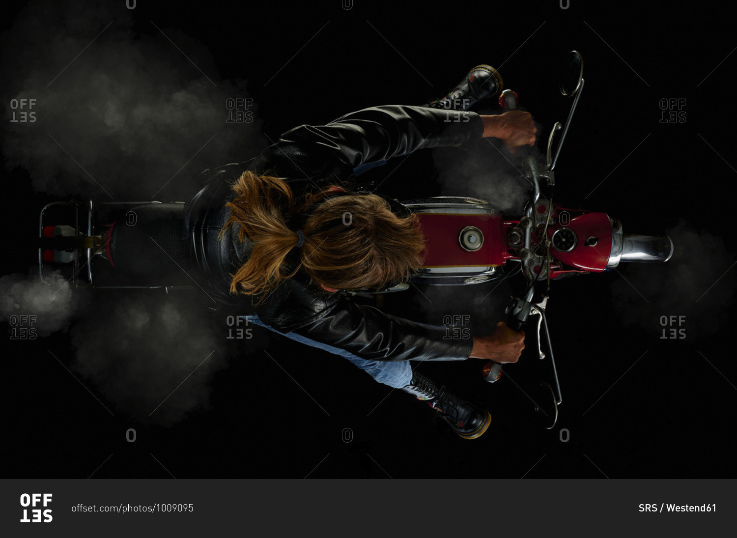Top view of woman on vintage motorcycle with black background and smoke (Zuendapp KS 125 Sport)