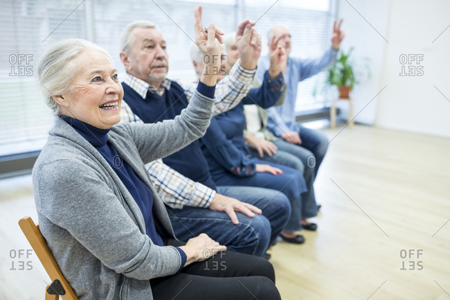 Senior citizens participating in group event in retirement home