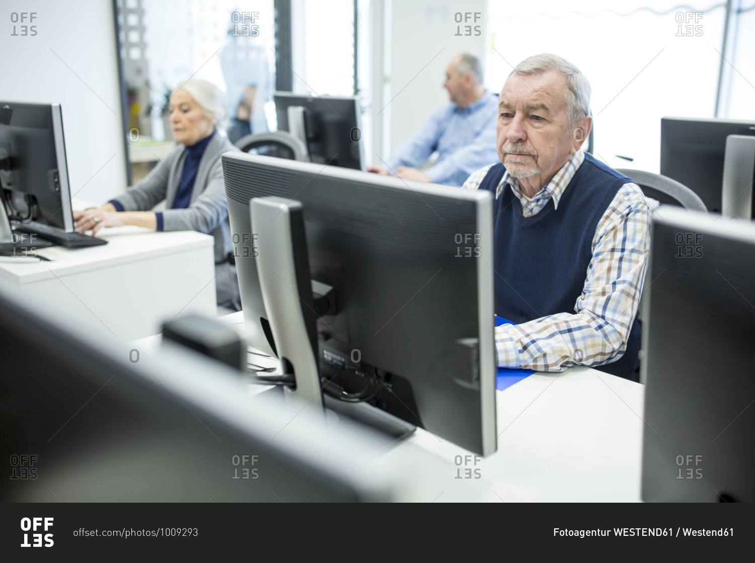 Active seniors attending computer course- working on PC