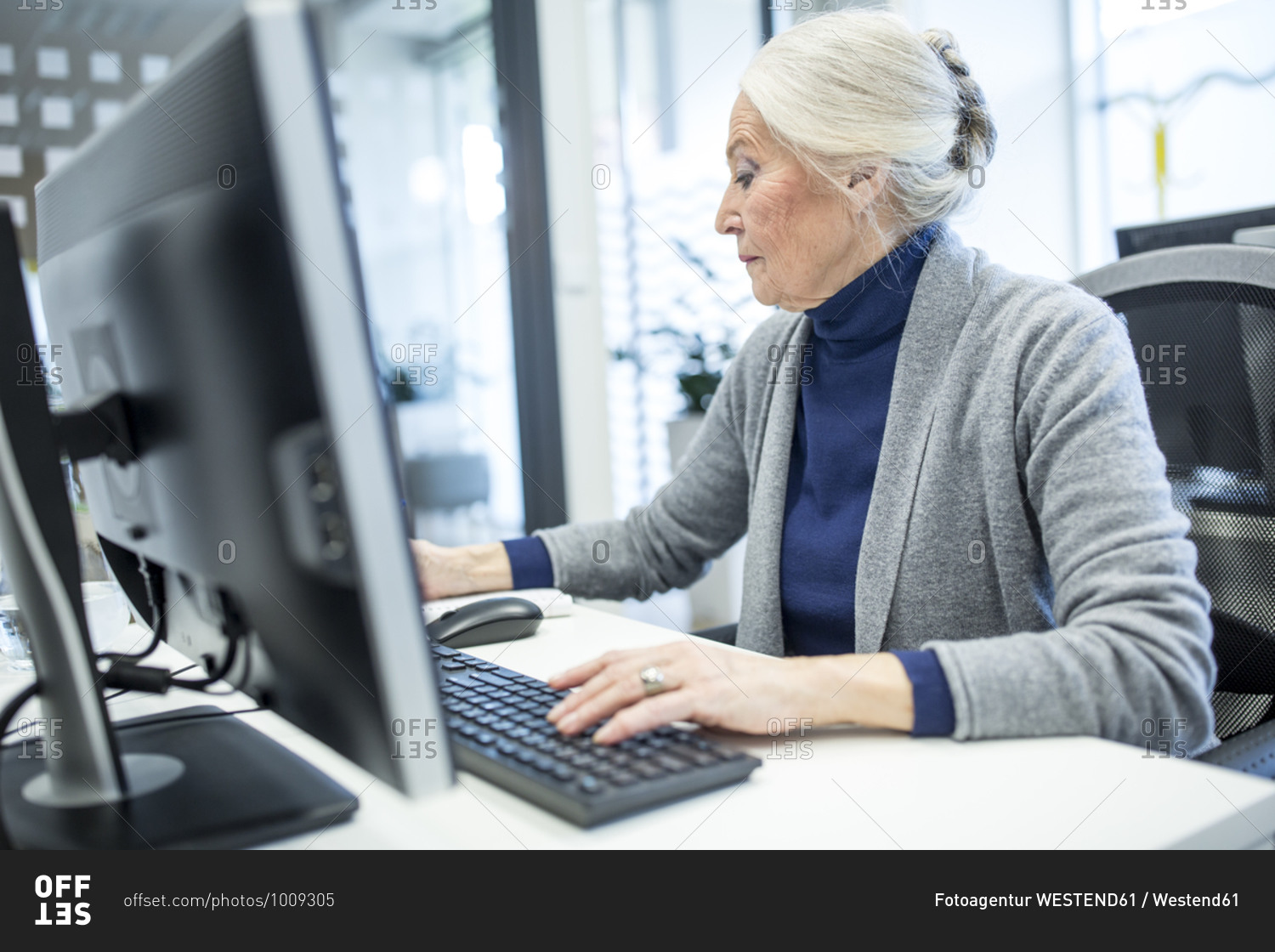 Senior woman attending computer course