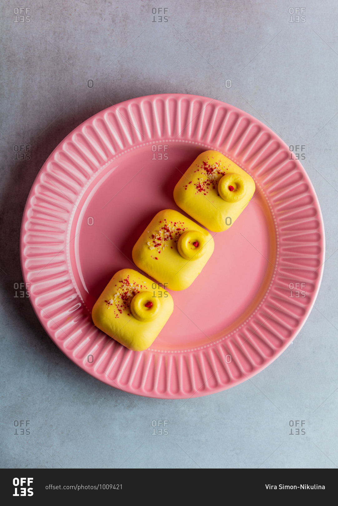 Three yellow raw desserts without gluten, sugar and flour on a plate