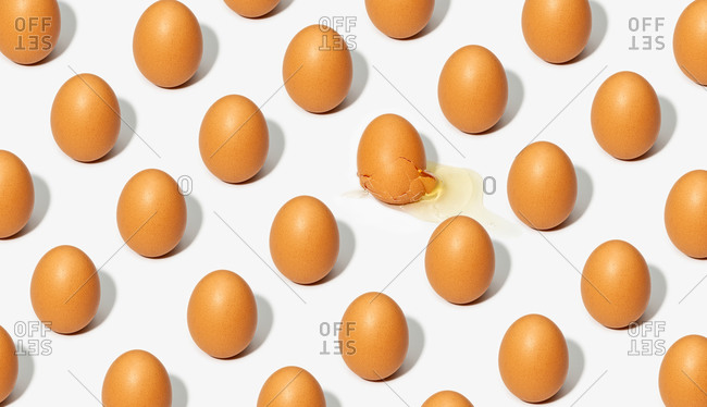 Seamless background of brown eggs placed in rows on white table in studio