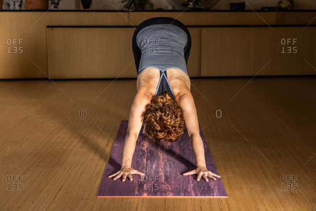 Young woman practicing downward facing tree asana in yoga studio. Adho  Mukha Vrksasana pose Stock Photo - Alamy