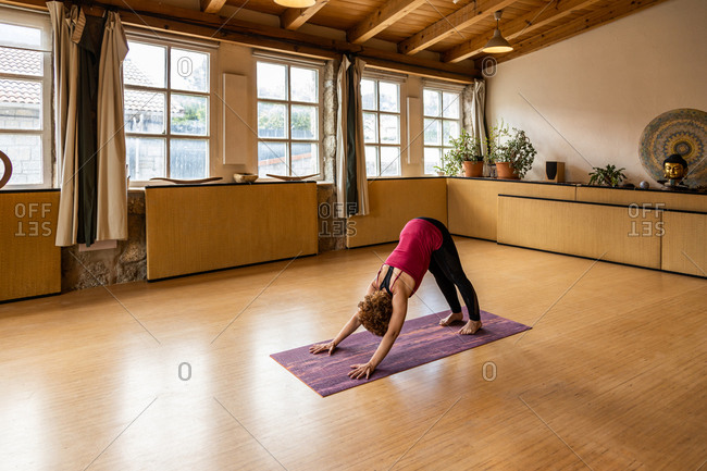 Young woman practicing downward facing tree asana in yoga studio. Adho  Mukha Vrksasana pose Stock Photo - Alamy