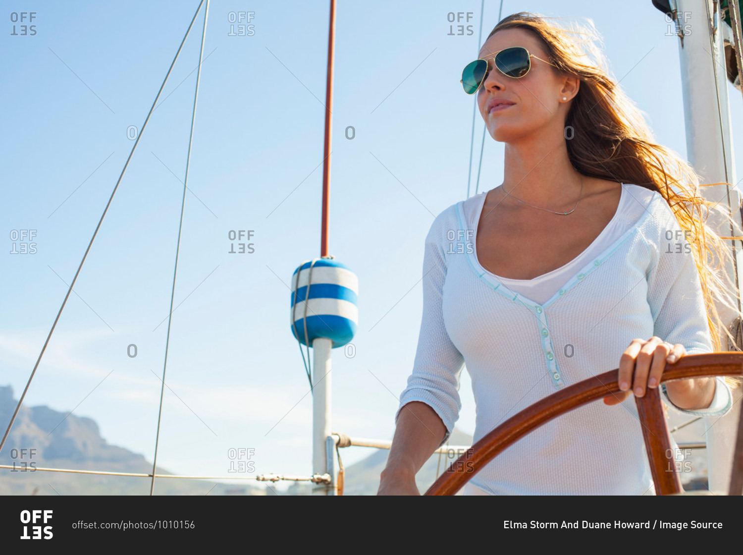 Woman steering a big yacht