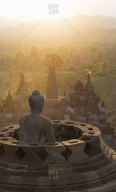 Buddha and morning mist, The Buddhist Temple of Borobudur, Java, Indonesia
