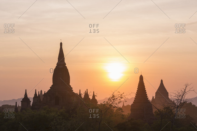 Silhouetted temples viewed from Dhammayazika Pagoda at sunset, Bagan, Mandalay Region, Myanmar