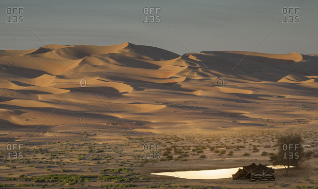 Bedouin tent and giant sand dunes in the Empty Quarter Desert, between Saudi Arabia and Abu Dhabi, UAE