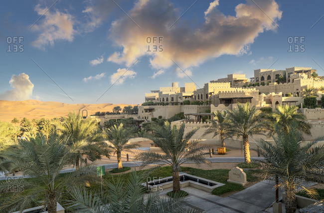 Palm trees in garden of Qsar Al Sarab desert resort, Empty Quarter Desert, Abu Dhabi, United Arab Emirate