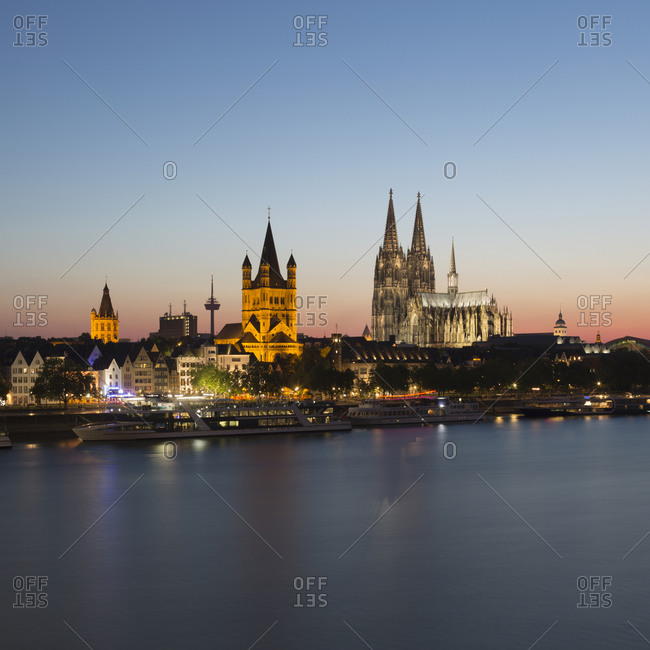 Waterfront cityscape with Town Hall, Great St Martin Church and Cologne Cathedral (Koelner Dom) at dusk, Cologne, Germany