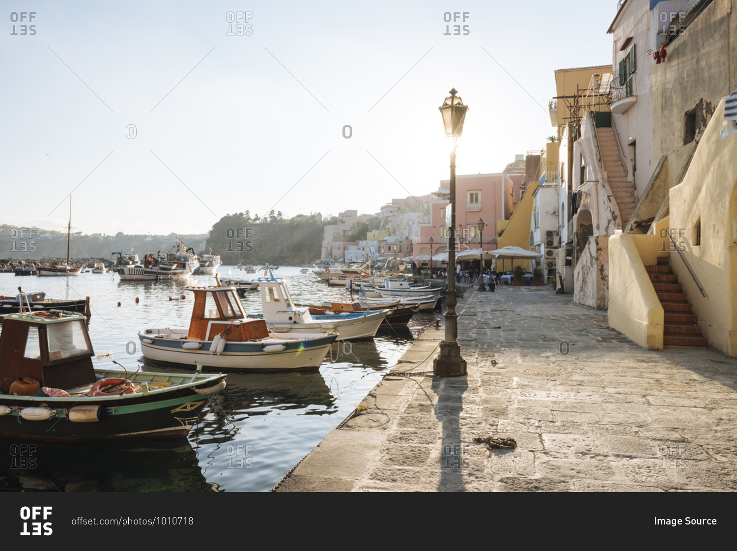 Waterfront restaurants and harbour boats at Procida island, Campania, Italy