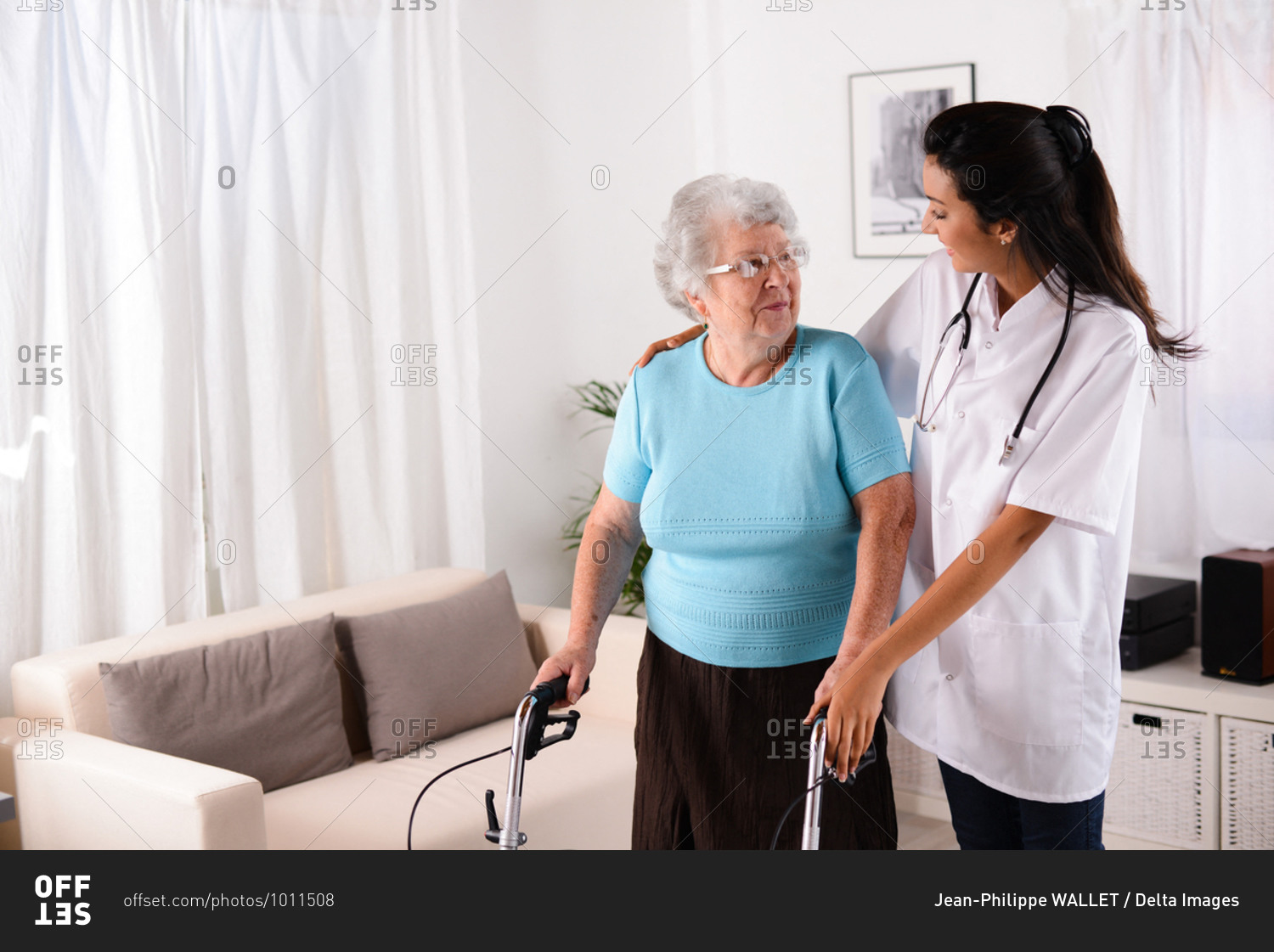 cheerful young rehab nurse helping elderly senior woman using a walker