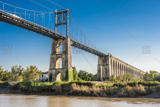 France, Charente Maritime, Tonnay-Charentes, suspension bridge (1842, historical building) on the Charente river, pedestrians and cyclists gateway