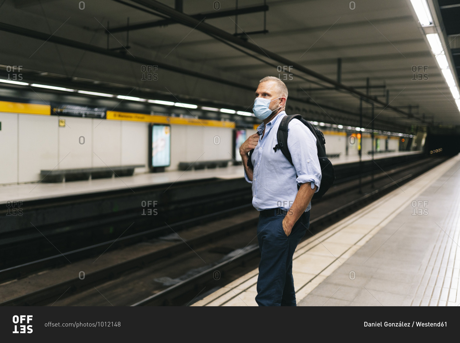 Businessman wearing face mask while standing at subway platform