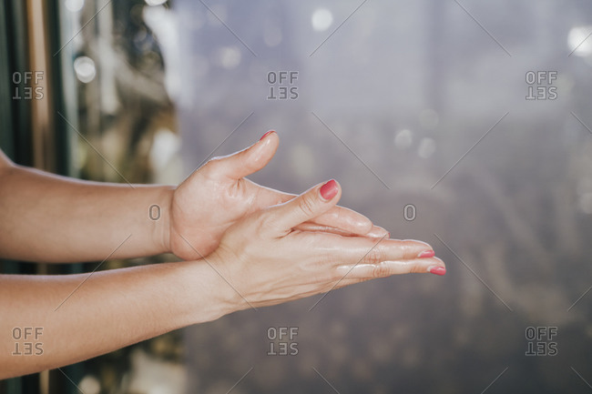 Close-up of female therapist hands with massage oil in spa