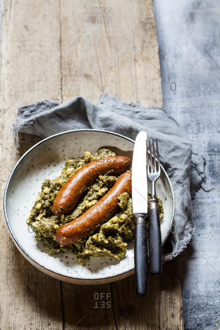Plate of smoked sausages with kale