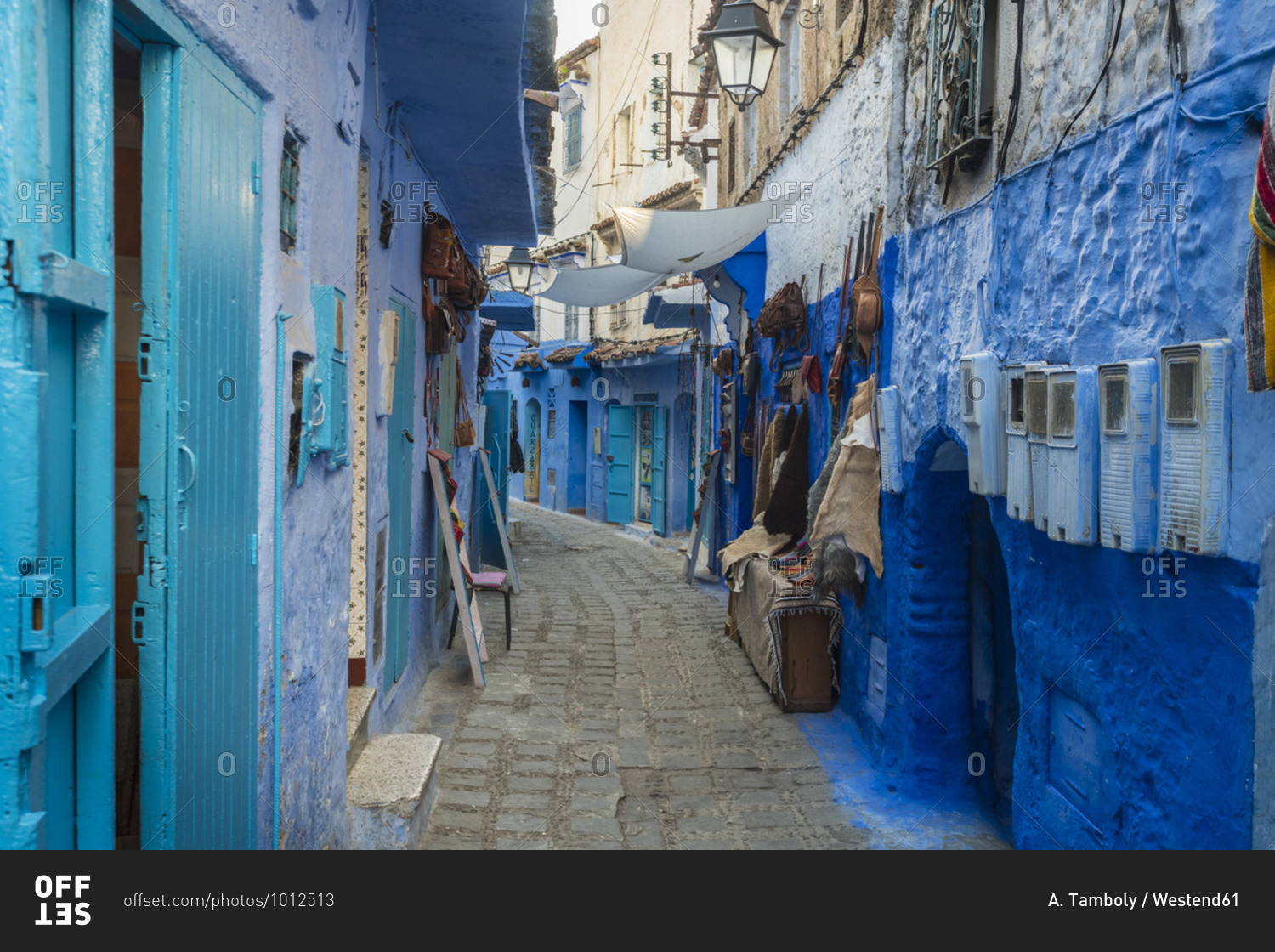 Alley amidst blue buildings at Chefchaouen- Morocco