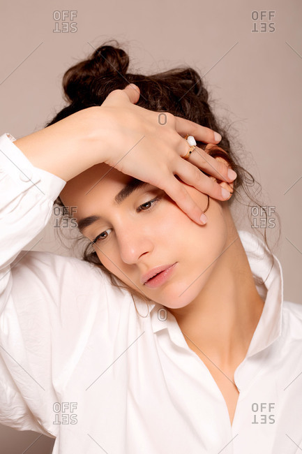 beautiful stylish young woman covering face with hand and posing isolated  on coral Stock Photo - Alamy