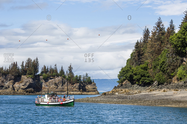 USA, Alaska, Halibut Cove - July 7, 2015: A ferry boat heads to the town of Halibut Cove, Alaska on a sunny day.