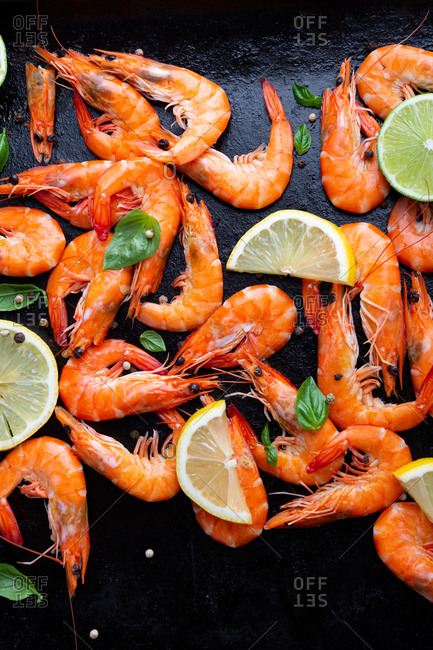 Overhead view of seafood prawn on dark cooking sheet