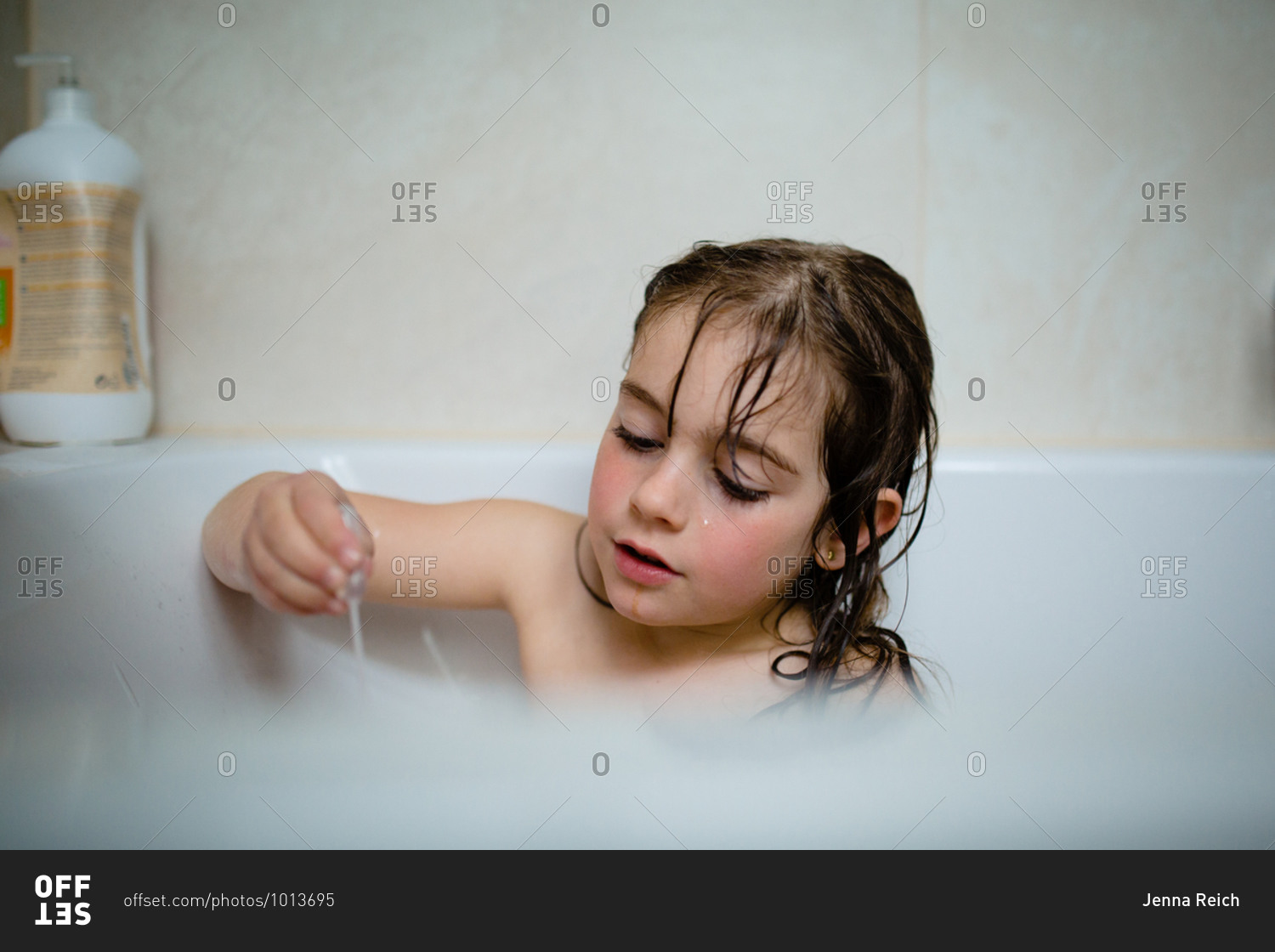 Little girl taking a bath stock photo - OFFSET