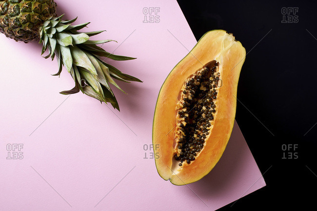 Still life composition with sliced papaya and pineapple
