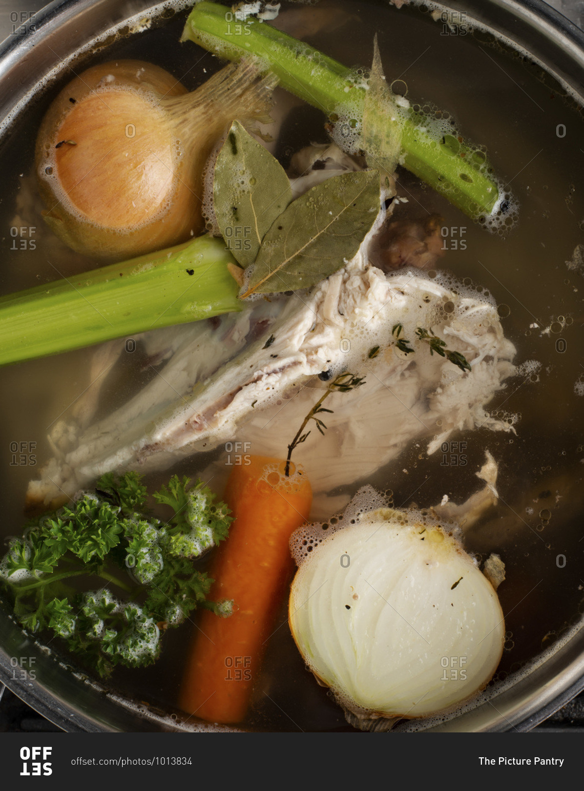 Cooking with chicken stock on the stove.
