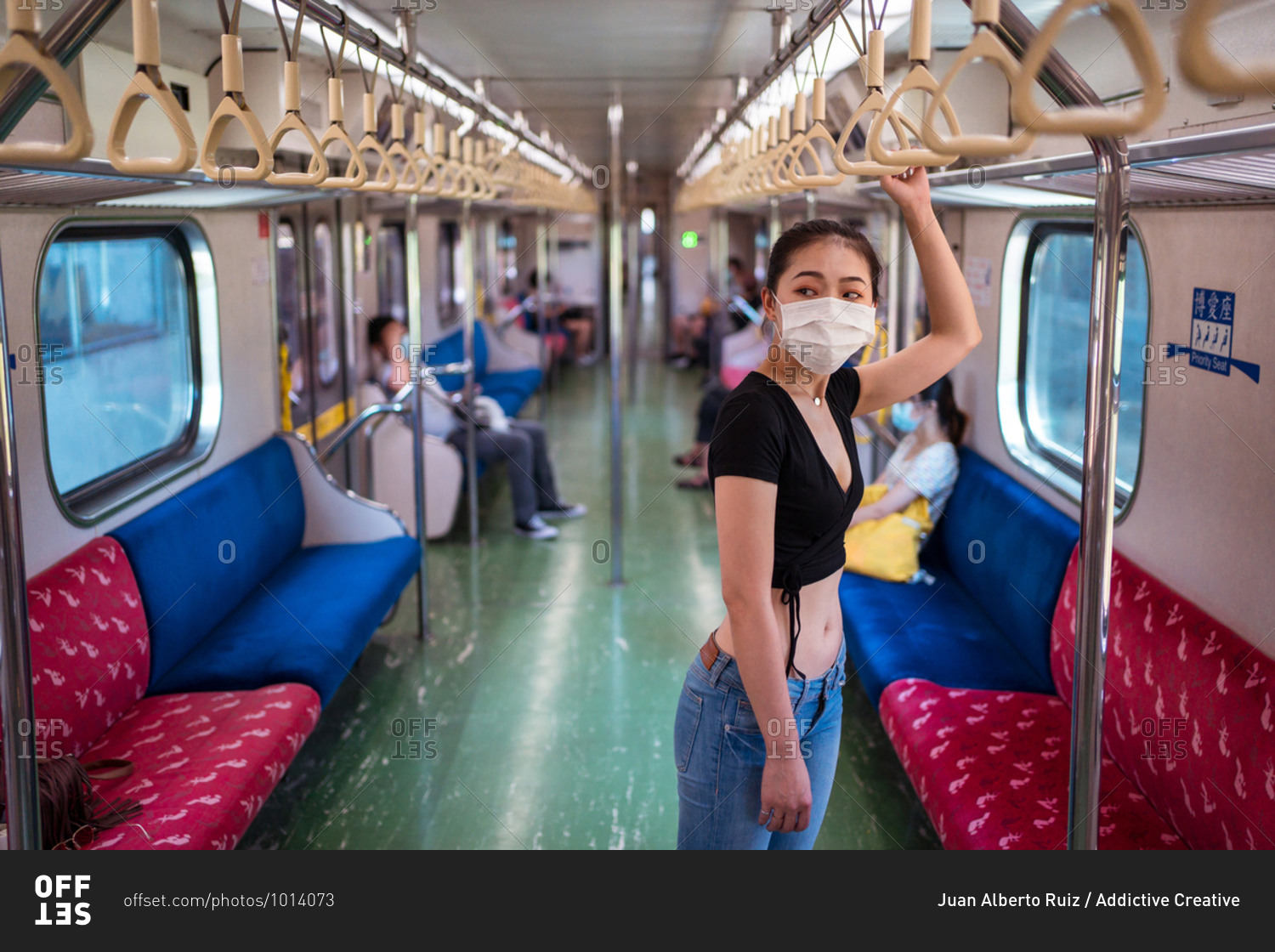Side view of ethnic female wearing protective mask traveling by train during coronavirus outbreak
