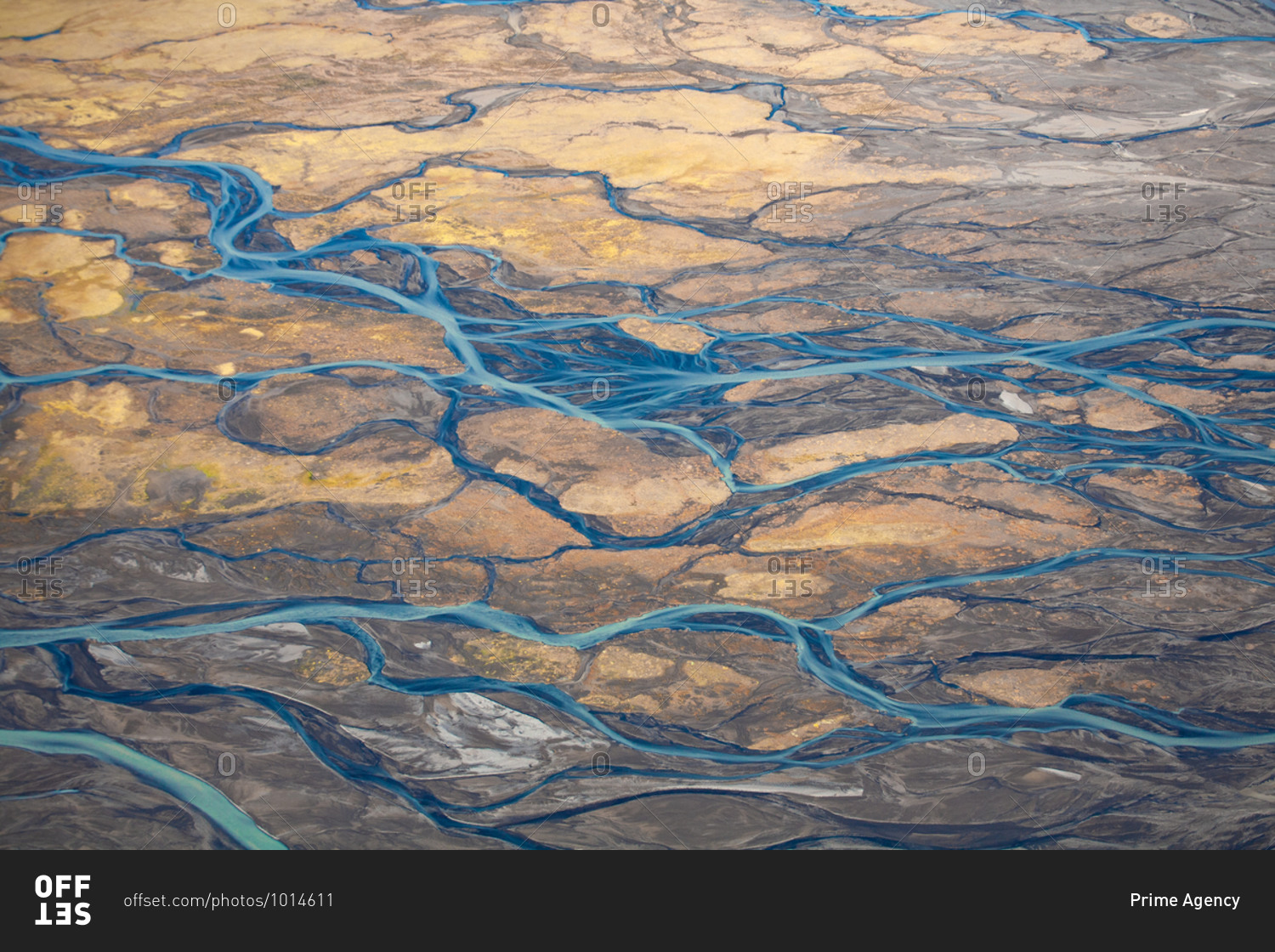 Bird\'s eye view over blue rivers and streams in rural Iceland