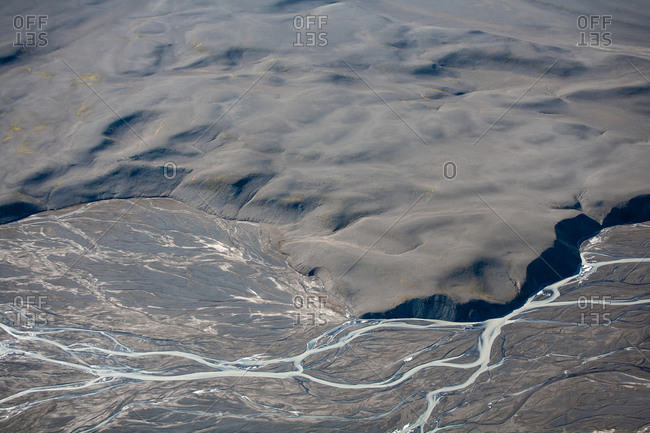Bird's eye view of rugged rural landscape with rivers and streams in Iceland