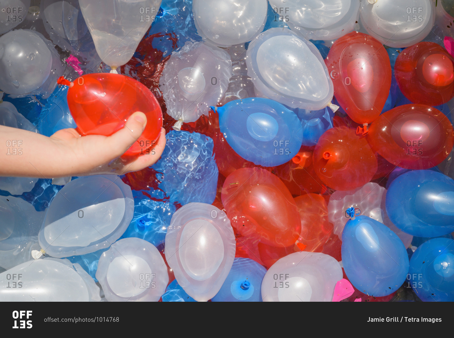 Close up of boy (4-5) playing with water balloons