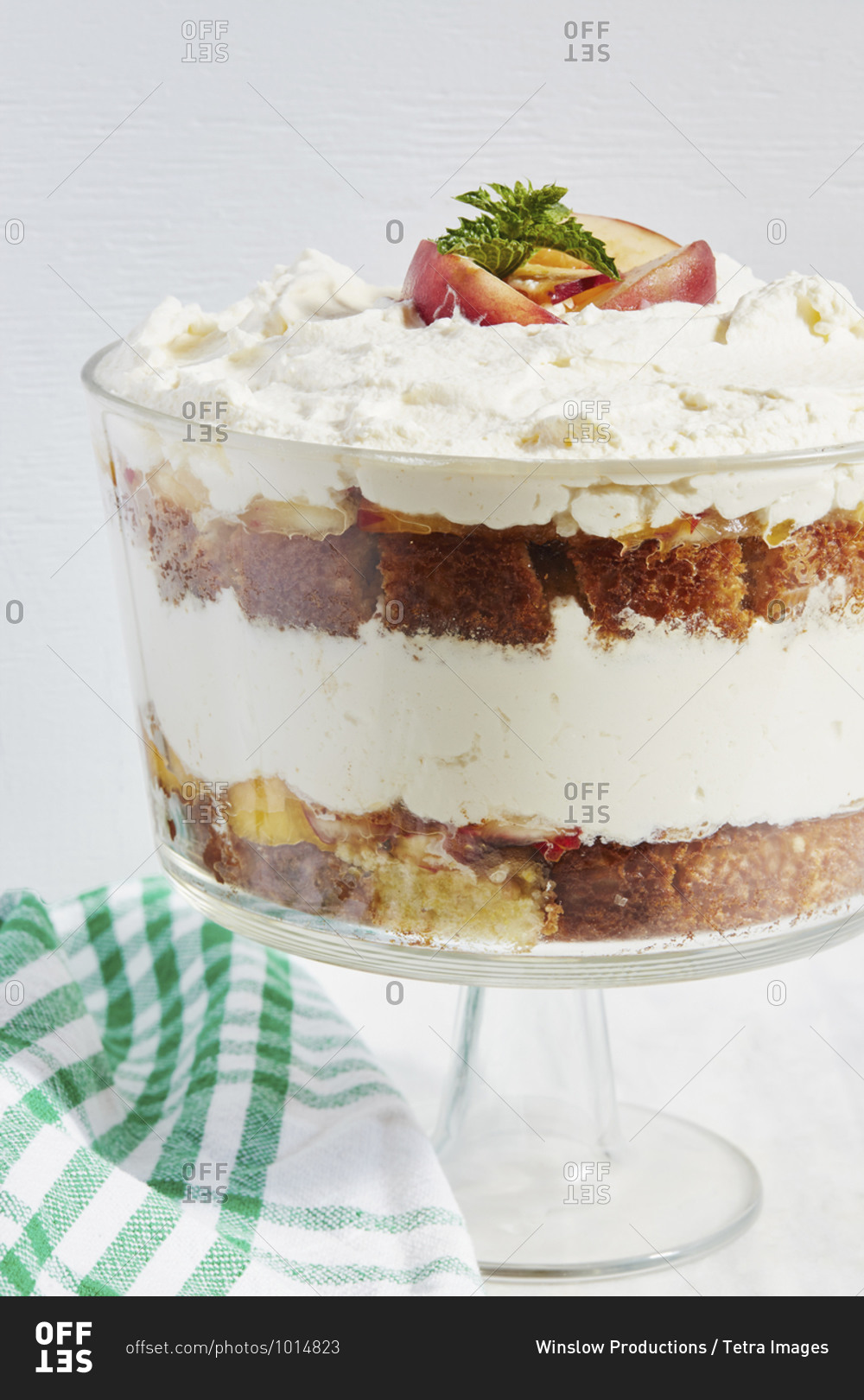 Trifle dessert with whipped cream and peaches