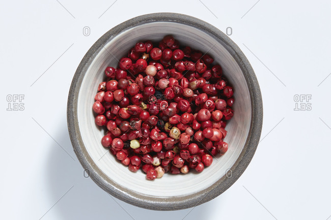 Red peppercorns in bowl - Offset
