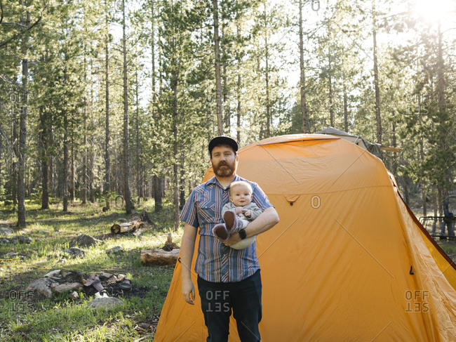 Father with baby boy (6-11 Months) standing by tent in Uinta-Wasatch-Cache National Forest