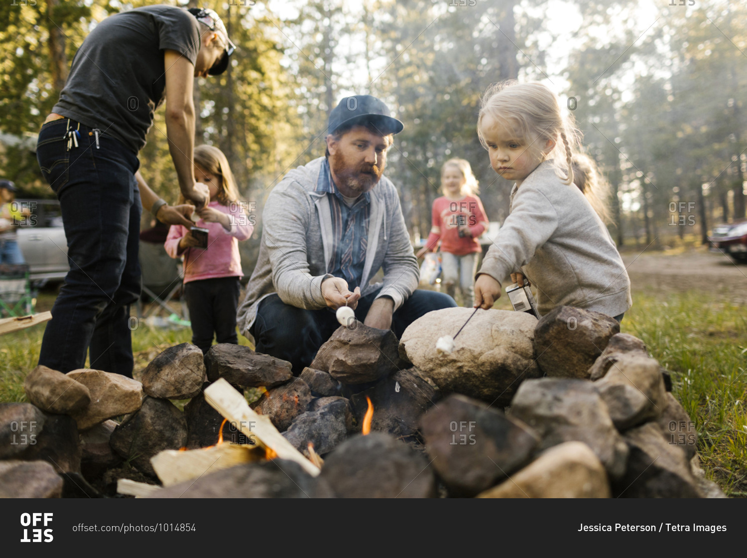 Family with three girls (2-3, 4-4, 6-7) roasting marshmallows above campfire, Wasatch-Cache National Forest