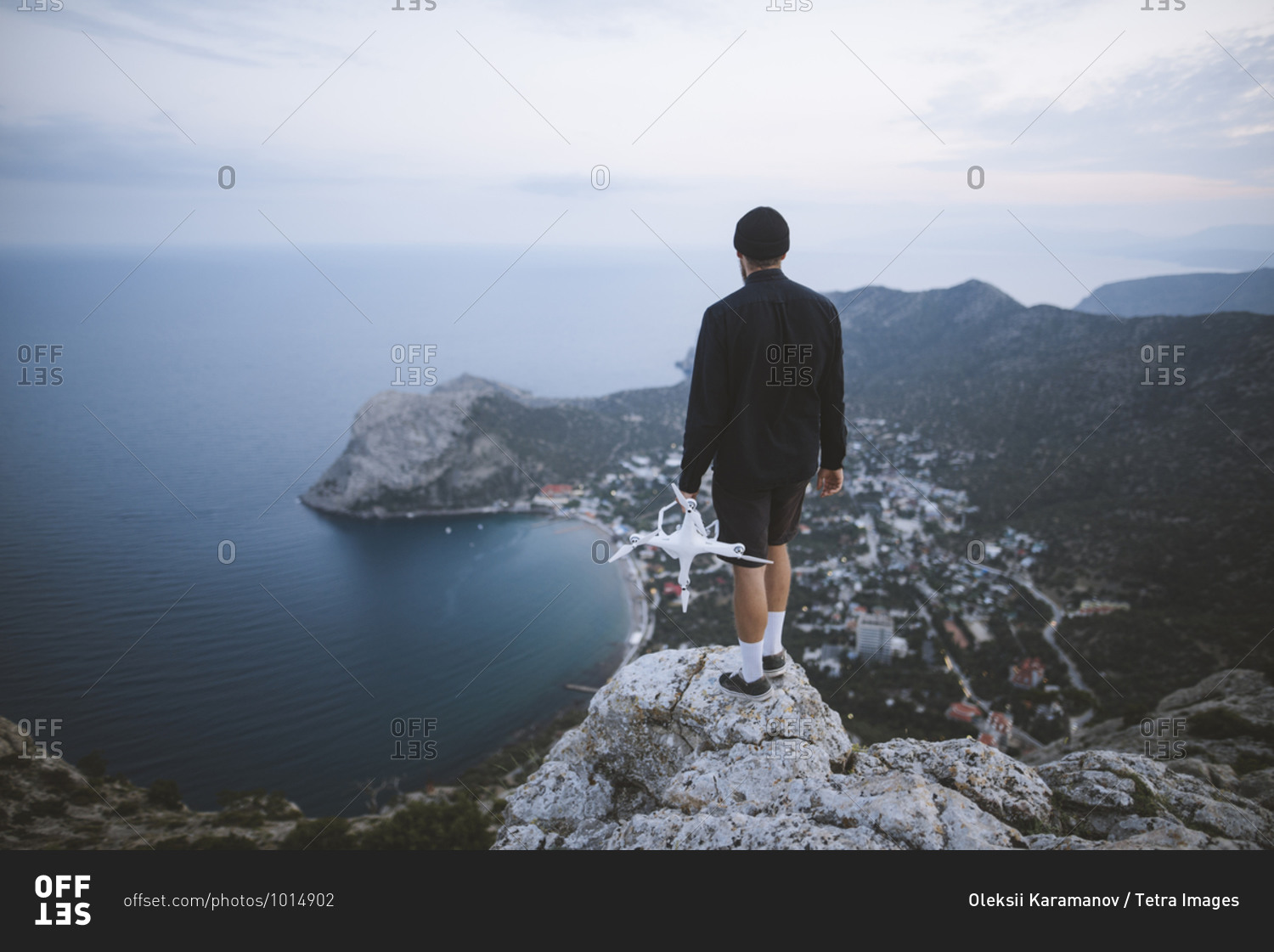 Italy, Liguria, La Spezia, Man at mountain top holding drone