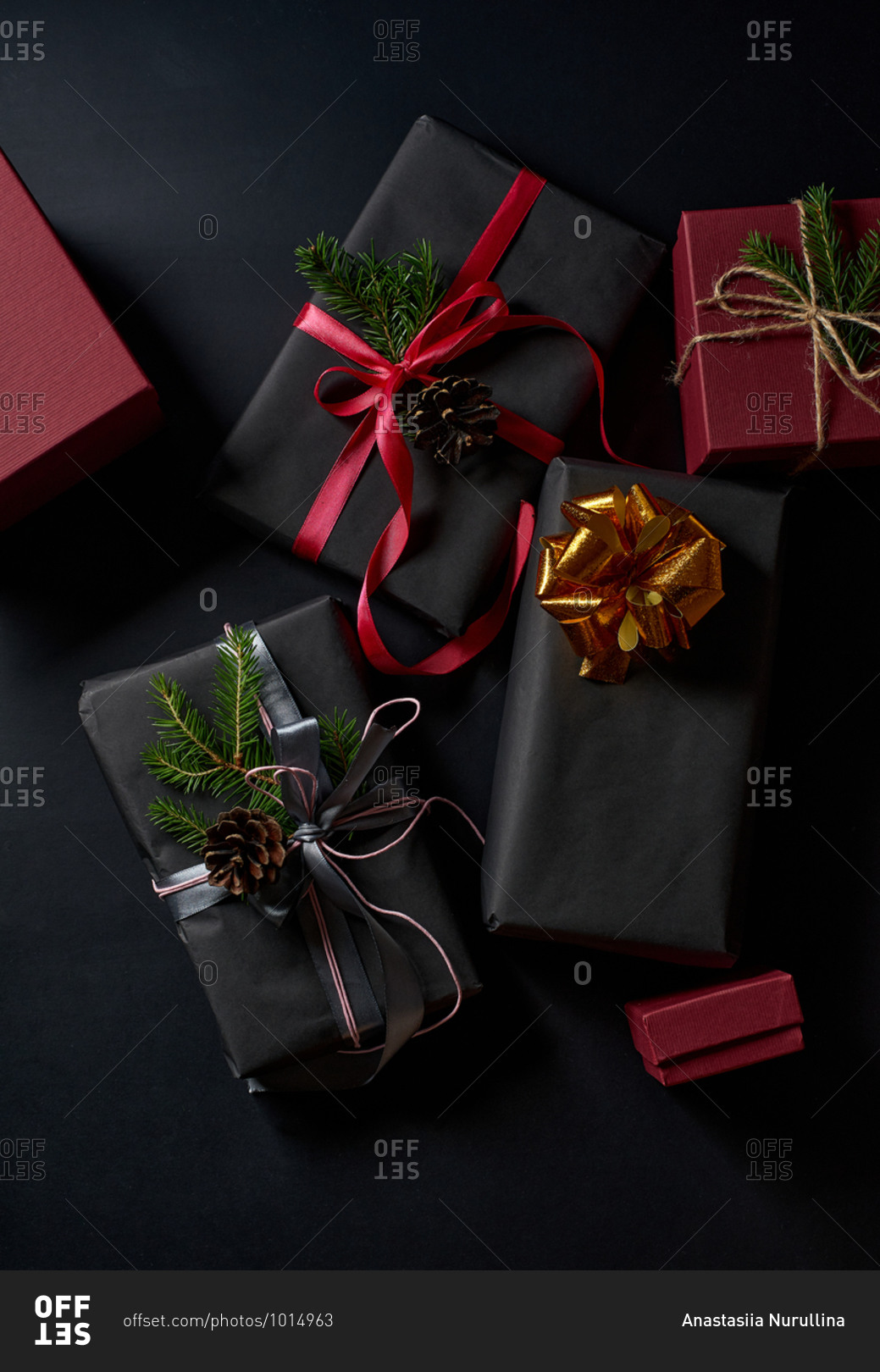 Wrapped and decorated gifts and boxes with presents on black background viewed from above