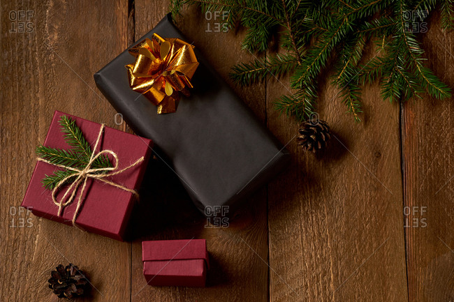 Top view of decorated christmas gifts and boxes with presents on wooden background