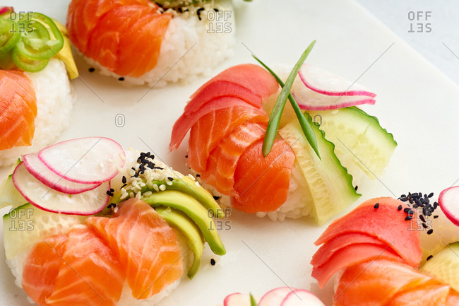 Closeup shot of sushi donuts with salmon and veggies