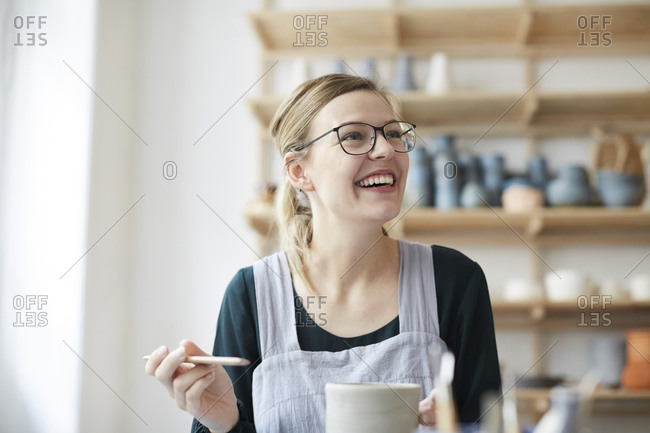 Smiling Young Woman Working in Art Pottery Studio Stock Image