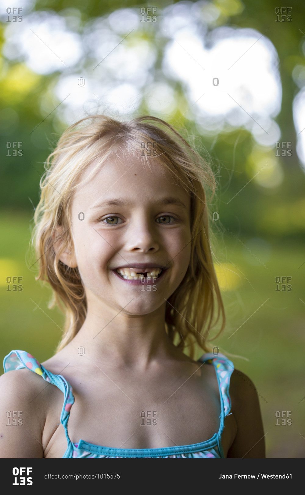 Cute girl with gap toothed standing outdoors