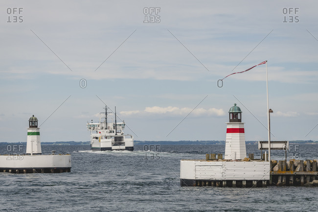 Denmark- Region of Southern Denmark- Soby- Two coastal lighthouses with ship sailing away in background
