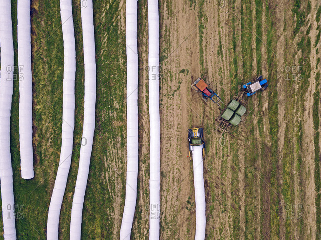 Aerial view of wrapped hay bales drying in field