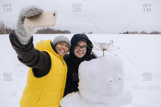 building a snowman stock photos - OFFSET