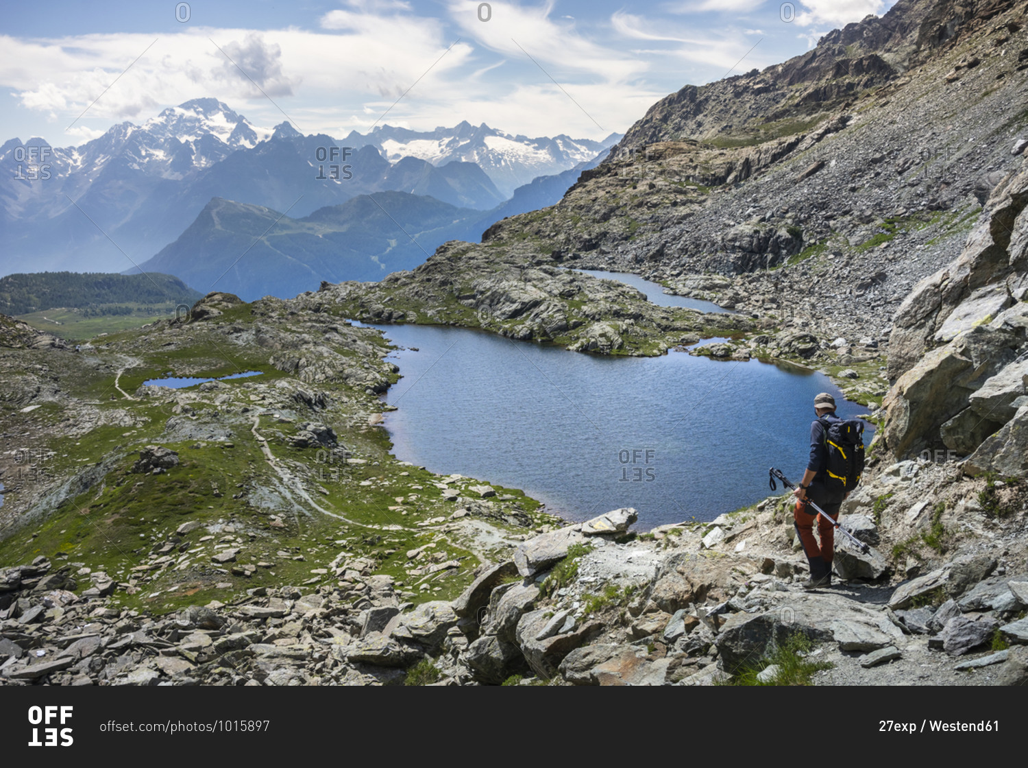 Man hiking by lake at Western Rhaetian Alps- Sondrio- Italy