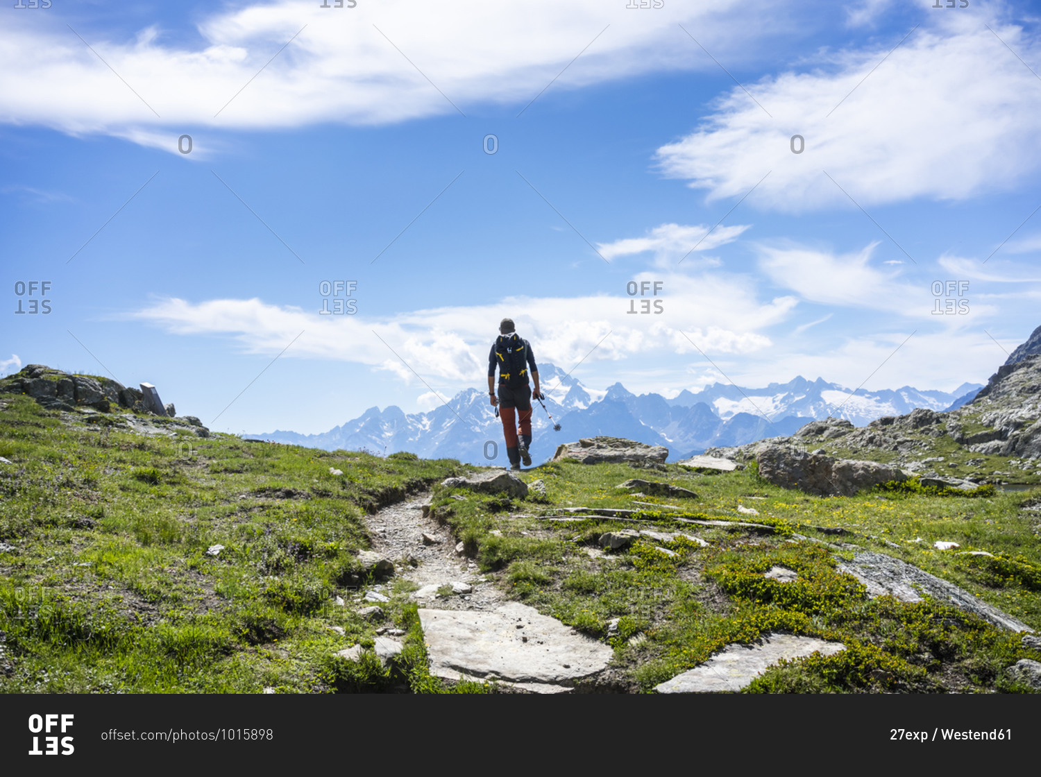 Man hiking on mountain path at Western Rhaetian Alps- Sondrio- Italy