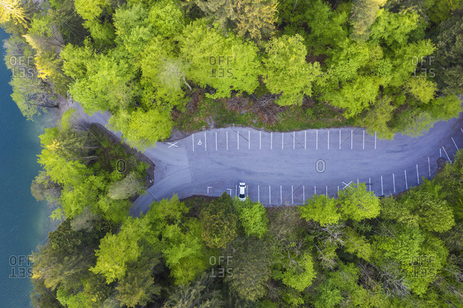 Drone view of empty parking lot on shore of Alatsee lake